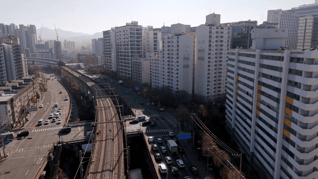 A bustling city with roads and railways