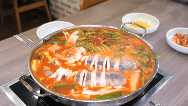 Spicy squid kalguksu boiling in pot