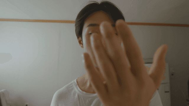 Man looking at his hand indoors