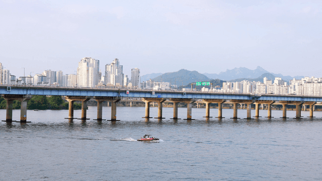 Bridge over a river with city skyline