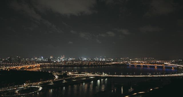 Illuminated Cityscape and River at Night