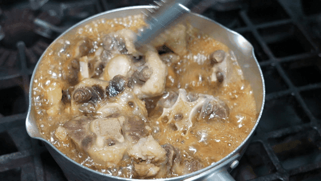 Oxtail stew simmered in pot on stove