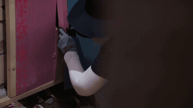 Person working on wall insulation at construction site