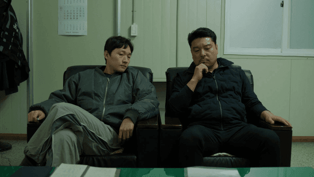 Two men sitting in an office talking