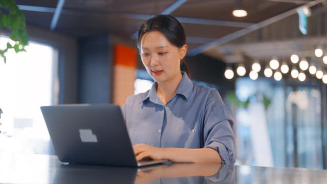 Woman working on a laptop in an office