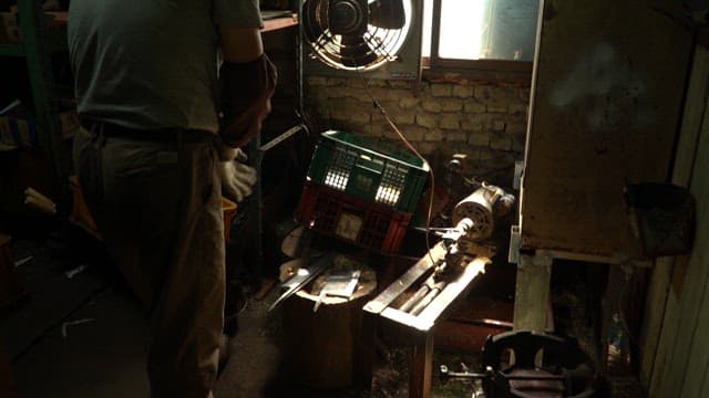 Worker in a dimly lit workshop