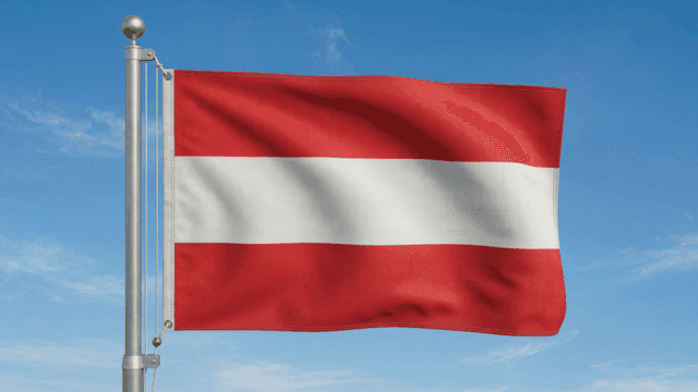 Austrian flag waving against a clear sky