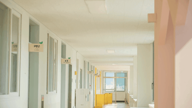 Empty elementary school hallway with classroom sign