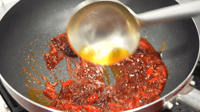Mala sauce stir-fried with red chili peppers in pan