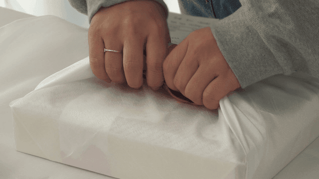 Hand wrapping gift with traditional cloth