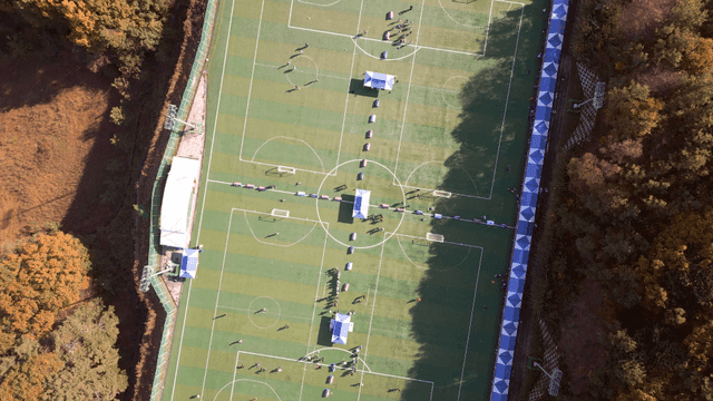 Aerial view of soccer field surrounded by trees