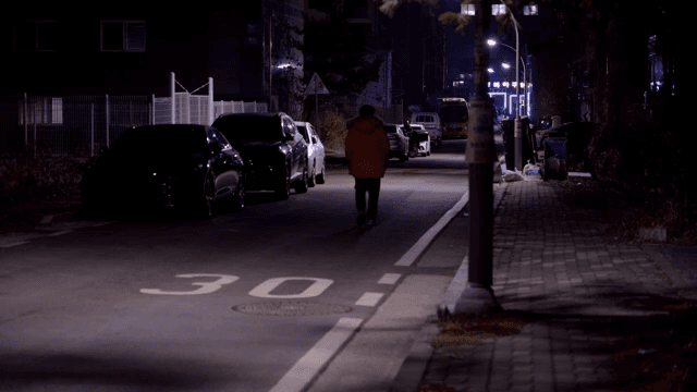 A person walking down a quiet street at night