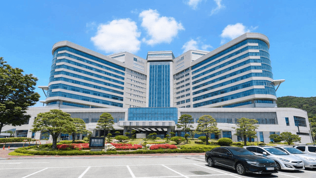 Modern hospital building with parking lot