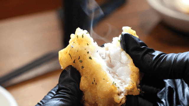 Scene of splitting codfish fritters by hand