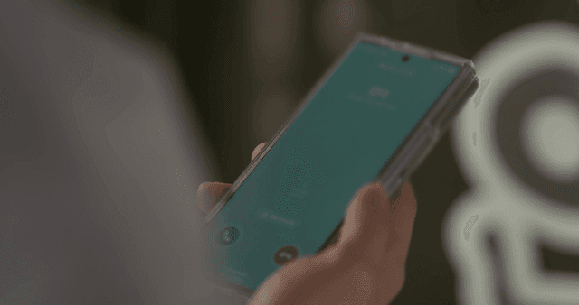 Person holding smartphone with incoming call