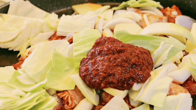Dakgalbi and vegetables served on hot plate