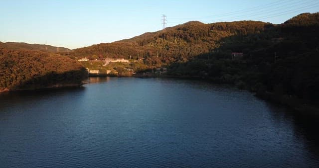 Tranquil lake surrounded by lush hills