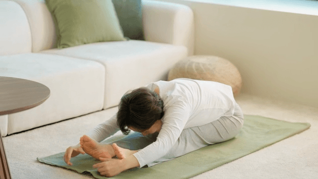 Woman stretching indoors
