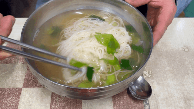 Bowl of banquet noodles soup with vegetables