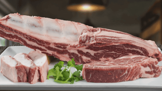 Fresh raw meat on a plate with herbs