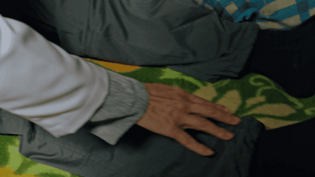 이불 위 노인 다리 반응을 검사하는 의사