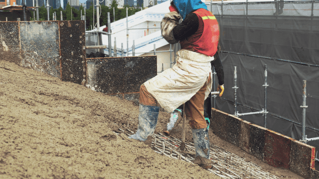 Construction worker pouring concrete