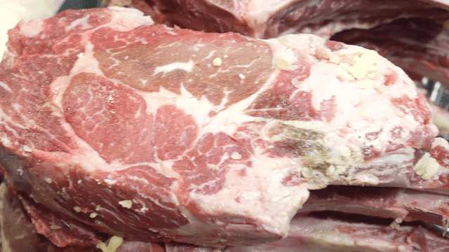 Raw meat with butter on grill