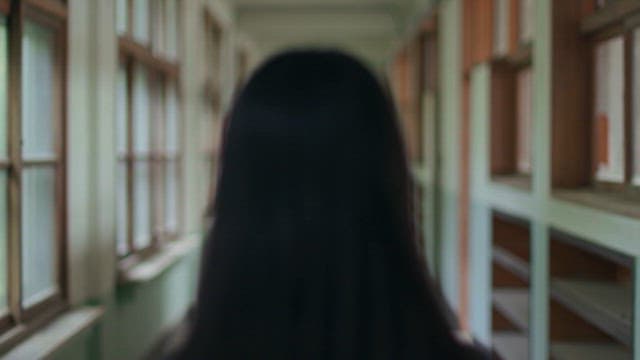 Woman standing in blurry corridor