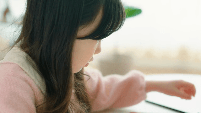 Child drawing with colored pencils