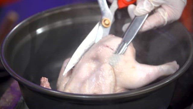 Cooked chicken cut with scissors