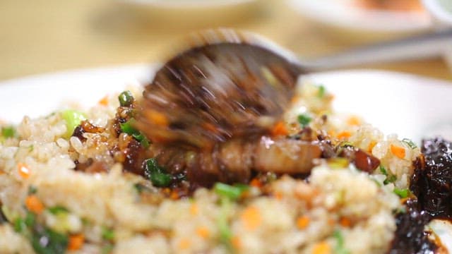 Spoonful of fried rice with vegetables and Jjajang sauce