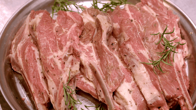 Raw lamb ribs seasoned with herbs