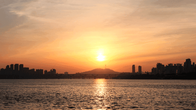 Sunset over river and skyscrapers
