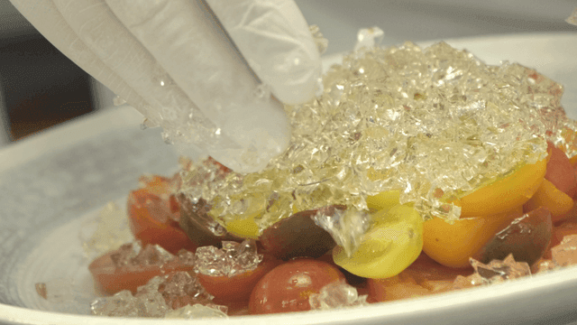 Colorful tomato salad with jelly on plate