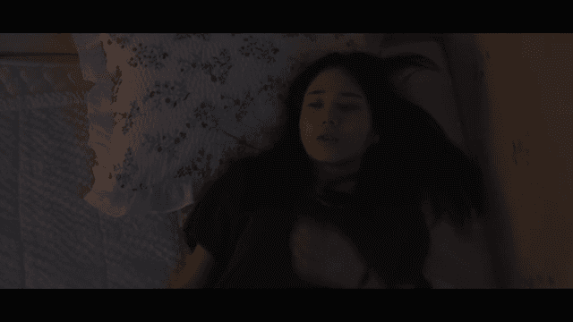 Woman lying in bed at night