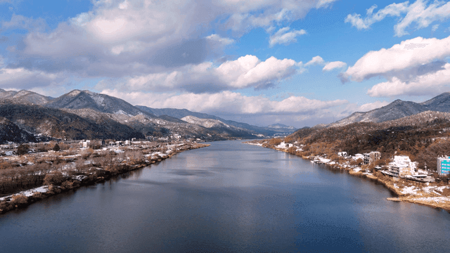 Quiet river flowing between snow-covered mountains