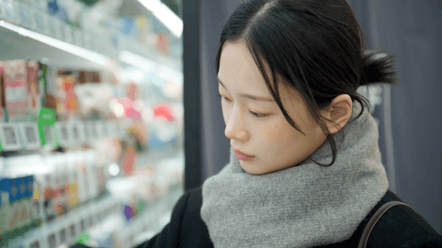 Woman shopping carefully at grocery store