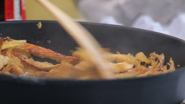 Stir-frying dried pollack in a hot frying pan