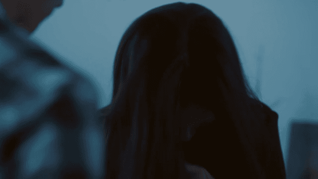 Woman with bruised face talking in living room