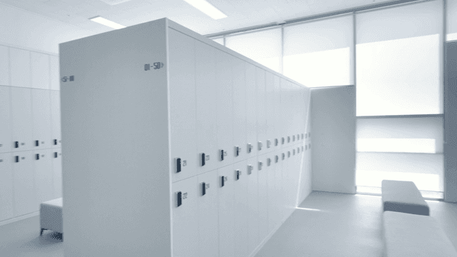 Modern changing room with white lockers