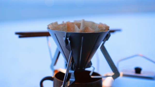 Making coffee with portable gears outdoors on a snowy day