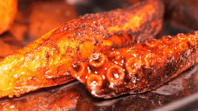 Grilled octopus tentacle on a tray