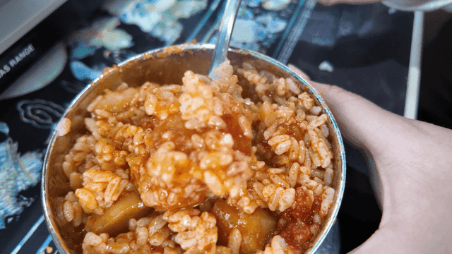 Bowl of rice mixed with spicy chicken stew broth