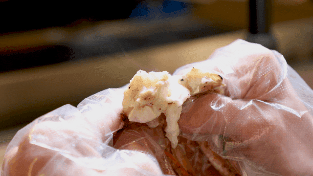 Pressing cooked crab meat by hand