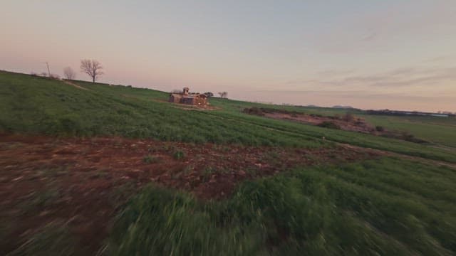 Rustic barn on a vast green field