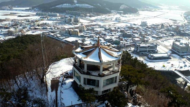 Observatory on a hill overlooking the snowy coastal city