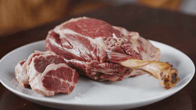Plate of raw lamb with bones