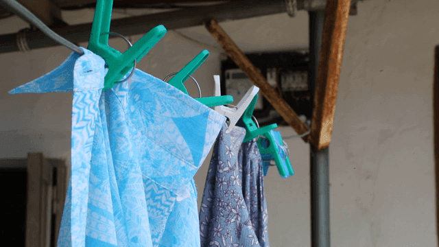 Clothes hanging on a line with pegs