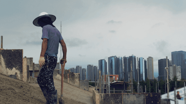 Worker shoveling on a construction site