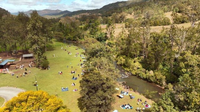 People enjoying a picnic by the river